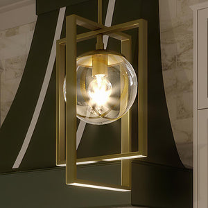A gorgeous pendant lamp from the Canton Collection, featuring a brushed bronze finish, hanging over a kitchen island.