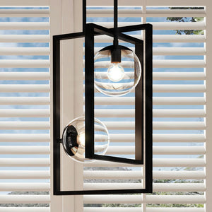 An UHP3261 Minimalist Pendant Light, 20.5"H x 13.5"W, Midnight Black Finish, Canton Collection beautiful hanging over a window with shutters.