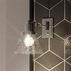 A unique urban lamp with a black and white tiled wall.