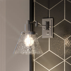 A unique urban lamp with a black and white tiled wall.