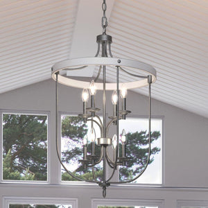 A unique French Country chandelier, 33.75"H x 21"W, with a luxurious galvanized steel finish from the Adelaide Collection by Urban Ambiance, hanging over a window in
