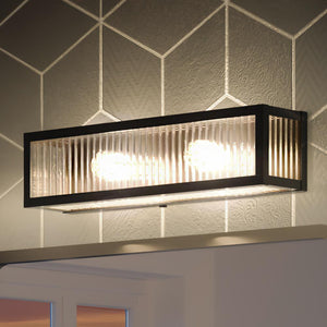 A beautiful Urban Ambiance UHP3581 Minimalist Bath Vanity Light with a geometric pattern on the wall from the Bismarck Collection.