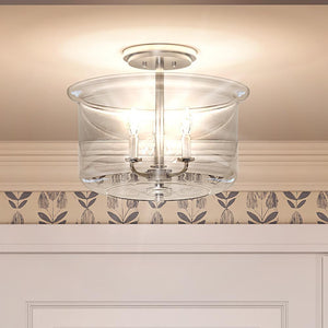 A beautiful lighting fixture in a room with a wallpapered ceiling.