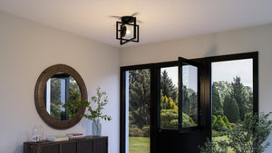 A room with a unique UHP4021 Minimalist Ceiling Light 9.75''H x 12''W, Midnight Black Finish, Singleton Collection by Urban Ambiance and a mirror.
