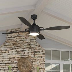 An Urban Ambiance black ceiling fan with a beautiful stone fireplace.
