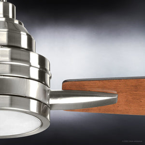 Close-up of the Urban Ambiance UHP9041 Mid Century Modern Indoor Ceiling Fan from the Tybee Collection, showcasing its brushed nickel motor housing and wooden blades, designed with sleek mid-century modern lines, set against a gradient background.