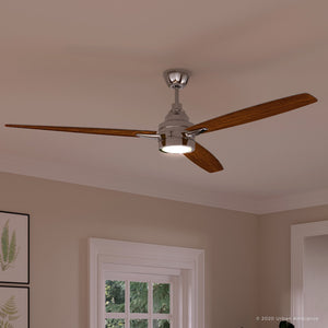 The UHP9043 Mid Century Modern Indoor Ceiling Fan from Urban Ambiance’s Tybee Collection features three wooden blades and a central light fixture in polished chrome, shown mounted on a white ceiling in a room adorned with framed art and a window.