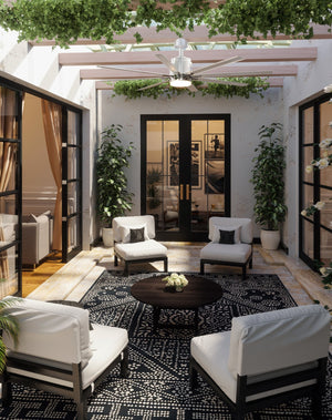 An outdoor patio with white Urban Ambiance furniture and plants.