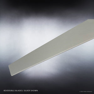 A single blade from the Urban Ambiance UHP9070 Modern Indoor Ceiling Fan (Camden Collection) is displayed against a gradient gray background, emphasizing the brushed nickel finish and sleek design. Text in the corner reads, “Reversible Blades: Silver Shown.”.