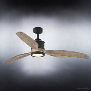 The UHP9090 Modern Indoor Ceiling Fan from Urban Ambiance’s Lewes Collection features three solid wood blades and a central LED light fixture, mounted on a dark ceiling in its charcoal finish, gently illuminating the space.