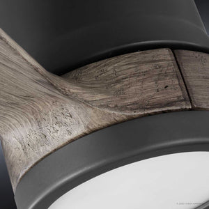 Close-up of the UHP9090 Modern Indoor Ceiling Fan from Urban Ambiance’s Lewes Collection, showcasing a smooth charcoal-finished top, wooden accent with visible grain that evokes solid wood fan blades in modern ceiling fans, and a white diffuser at the bottom.