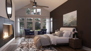 Modern bedroom with a dark accent wall, large windows, cozy bed, fireplace, two blue chairs, and the Urban Ambiance UHP9090 Modern Indoor Ceiling Fan from the Lewes Collection (15.5″H x 60″W, Charcoal) featuring solid wood blades.