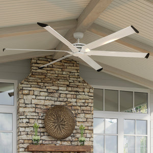 An Urban Ambiance UHP9130 Industrial Indoor or Outdoor Ceiling Fan, 15.5"H x 96"W, Matte White from the Key West Collection with a gorgeous stone fireplace.