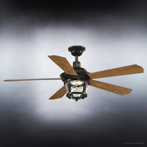 The Urban Ambiance UHP9180 Modern Farmhouse Indoor or Outdoor Ceiling Fan from the Catalina Collection showcases four wooden blades and an Olde Bronze finish, with a central hammered glass shade, photographed against a gray gradient background.