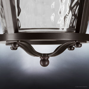 Close-up of the lower part of the Urban Ambiance UHP9180 ceiling fan from the Catalina Collection, featuring a metal frame with a curved support and hammered glass shade, finished in Olde Bronze; suitable for indoor or outdoor use.