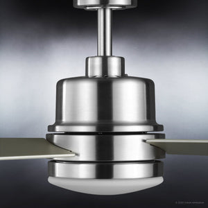 Close-up of the Urban Ambiance UHP9221 Modern Indoor Ceiling Fan from the Capitola Collection, featuring a brushed nickel finish, two blades, and a white LED light fixture, set against a gray background.