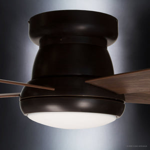 A close-up view of the Urban Ambiance UHP9230 Traditional Indoor Ceiling Fan from the Beaufort Collection showcases its Olde Bronze finish, three American Walnut blades, and a central white frosted LED light, set against a gradient background.