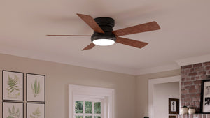 The Urban Ambiance UHP9230 Traditional Indoor Ceiling Fan from the Beaufort Collection, featuring an Olde Bronze finish and measuring 11.6 inches high by 52 inches wide, is mounted on a white ceiling in a modern room with framed art and a partial brick wall.