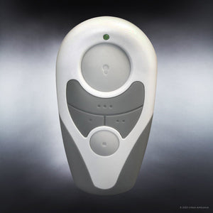 A compact handheld remote control—featuring three buttons, a subtle green indicator light, and a sleek gray-and-white design—is displayed against a gradient background, thoughtfully crafted to effortlessly operate your Urban Ambiance UHP9232 Traditional Indoor Ceiling Fan (11.6″H x 52″W) from the Beaufort Collection.