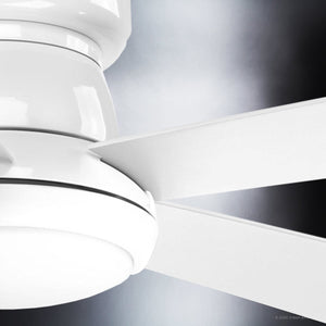 Close-up view of the Urban Ambiance UHP9232 Traditional Indoor Ceiling Fan from the Beaufort Collection, shown in white with three blades. The fan features an integrated LED light with an opal glass diffuser, set against a softly blurred background with dark and light gradients.