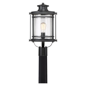 The Urban Ambiance UQL1010 Mid-Century Modern Outdoor Post Light from the Cannes Collection features a black silk finish and a 19.5-inch tall, square-mounted post. Its cylindrical seeded glass enclosure showcases a visible lightbulb inside, while the subtly textured glass enhances the vintage-inspired appeal of this modern lantern.