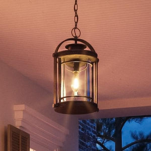 A unique and luxurious lantern from the Cannes Collection hanging from a porch at dusk.