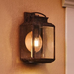 A beautiful Urban Ambiance UQL1022 Tuscan Outdoor Wall Light, 18"H x 10"W, Royal Bronze Finish, Casablanca Collection on a wall.