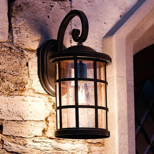 A unique UQL1045 Craftsman Outdoor Wall Light, 17.75"H x 10"W, Parisian Bronze Finish, Vienna Collection by Urban Ambiance on a stone wall.