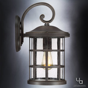 The Urban Ambiance UQL1045 Craftsman Outdoor Wall Light from the Vienna Collection features a Parisian Bronze finish, curved arm design, and clear seeded glass panels that reveal a visible bulb inside. Measuring 17.75″ high by 10″ wide and built with marine-grade construction, this stylish wall sconce adds an elevated touch to any exterior.