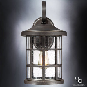 An Urban Ambiance UQL1045 Craftsman Outdoor Wall Light from the Vienna Collection, measuring 17.75 inches high by 10 inches wide, is showcased in a Parisian Bronze finish with a marine-grade metal construction and clear glass panels revealing a visible light bulb inside, mounted against a plain background.