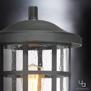 Close-up of the Urban Ambiance UQL1046 Vienna Collection Craftsman Outdoor Post Light in a natural black finish, featuring marine-grade construction and a glass enclosure with visible bulb, set against a gradient gray background.