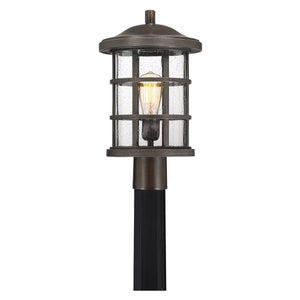The Urban Ambiance UQL1047 Craftsman Outdoor Post Light from the Vienna Collection features a Parisian Bronze finish and marine-grade construction, measuring 17.25″ high by 10″ wide. This elegant fixture showcases clear glass panels and a visible bulb inside a cylindrical metal frame, designed to be mounted on a black post.