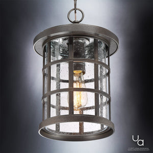 The Urban Ambiance UQL1049 Craftsman Outdoor Pendant Light from the Vienna Collection features a marine-grade cylindrical design with a Parisian Bronze finish, a metal grid frame, clear glass panels, and an exposed vintage-style bulb. Elegantly suspended from a chain, this 15.5″ high by 10″ wide pendant is both stylish and durable for outdoor spaces.