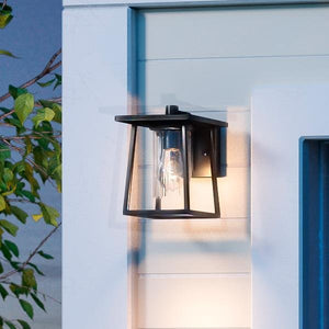 A unique and luxury UQL1090 Craftsman Outdoor Wall Light, 9"H x 6.5"W, Black Silk Finish, Lisbon Collection by Urban Ambiance on the side of a house