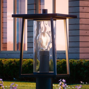 A gorgeous UQL1093 Craftsman Outdoor Post Light, 16"H x 9.5"W, Black Silk Finish from the Lisbon Collection by Urban Ambiance in front of a house