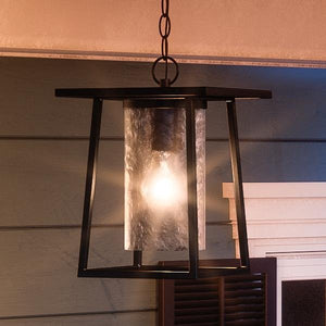 An UQL1094 Craftsman Outdoor Pendant Light, 13.5"H x 9.5"W, Black Silk Finish, Lisbon Collection hanging on a porch from Urban Ambiance, creates a