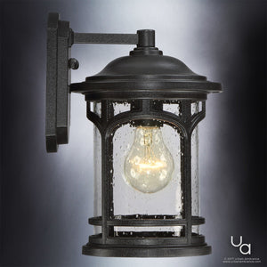 The Urban Ambiance UQL1100 Rustic Outdoor Wall Light from the Sydney Collection features marine-grade black silk finish, clear glass panels, and a visible bulb for timeless charm on any exterior wall. Measures 11