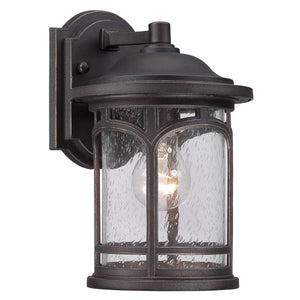 Illuminate your home’s exterior with the Urban Ambiance UQL1101 Rustic Outdoor Wall Light from the Sydney Collection. Measuring 11″ high by 7″ wide, this wall-mounted sconce features a Parisian Bronze finish and clear seeded glass panels that showcase the visible bulb inside. Built with marine-grade construction for weather resistance, it blends classic style and durable quality to enhance your curb appeal.