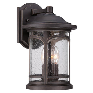 The Urban Ambiance UQL1103 Rustic Outdoor Wall Light from the Sydney Collection features a marine-grade construction in a Parisian Bronze finish, with clear seeded glass panels and two candle-style bulbs elegantly housed on a rectangular backplate. Measuring 14.5″ high by 9″ wide, this fixture offers both durability and classic style for your outdoor space.