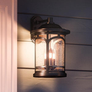 A gorgeous Rustic Outdoor Wall Light, 17.75"H x 11"W, from the Sydney Collection on the side of a house.