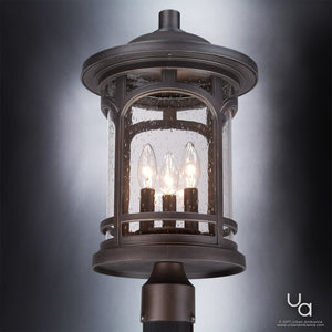 Certainly! Here’s a rewritten version of your sentence using the provided product data: The Urban Ambiance UQL1107 Rustic Outdoor Post Light from the Sydney Collection showcases a cylindrical seeded glass enclosure with raindrop-textured glass, three candle-style bulbs, and a round top in a Parisian Bronze finish. This 19-inch high by 11-inch wide fixture features marine-grade construction for enduring outdoor elegance.