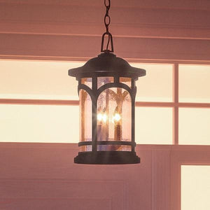 The Urban Ambiance UQL1108 Rustic Outdoor Pendant Light, 18"H x 11"W with a black silk finish from the Sydney Collection, hangs indoors in front of a window, blending modern rustic charm with classic design.