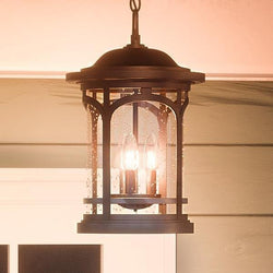A beautiful outdoor lantern hanging from a porch.