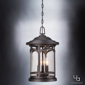 The Urban Ambiance UQL1109 Rustic Outdoor Pendant Light from the Sydney Collection features a Parisian Bronze finish, clear glass panels, and a sturdy marine-grade metal frame measuring 18″ high by 11″ wide. This lantern-style fixture contains two candle-shaped light bulbs.