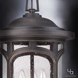 Close-up of the UQL1109 Rustic Outdoor Pendant Light from Urban Ambiance’s Sydney Collection, featuring a dark Parisian Bronze finish over durable marine-grade construction. Clear, seeded glass panels showcase two visible light bulbs inside, offering sophisticated charm for any exterior space. The Urban Ambiance logo appears in the bottom right corner.
