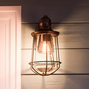 A unique and beautiful Vintage Outdoor Wall Lamp, 15"H x 8.5"W, Estate Bronze Finish, San Francisco Collection on the side of a house.