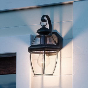 A beautiful Colonial Outdoor Wall Light from the Cambridge Collection on the side of a house.
