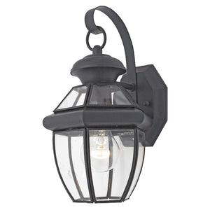 The Urban Ambiance UQL1140 Colonial Outdoor Wall Light from the Cambridge Collection features a black silk finish, clear glass enclosure showcasing a visible bulb, and a curved arm attached to a rectangular wall plate, creating an effortlessly timeless colonial silhouette. This fixture measures 11.5 inches high by 7 inches wide.
