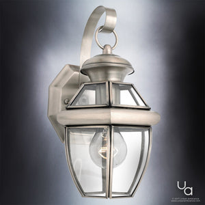 An Urban Ambiance Colonial Outdoor Wall Light with a clear glass shade creating a unique and gorgeous lighting fixture.
