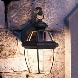 A beautiful Urban Ambiance Colonial Outdoor Wall Light on a stone wall.